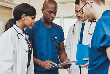 Clinicians looking at a tablet