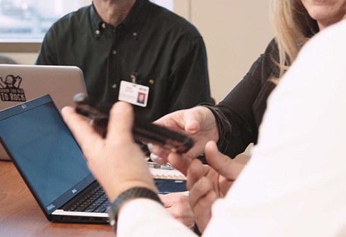 Spok Employees showing a client how to use Spok solutions