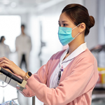 Clinician with mask using computer