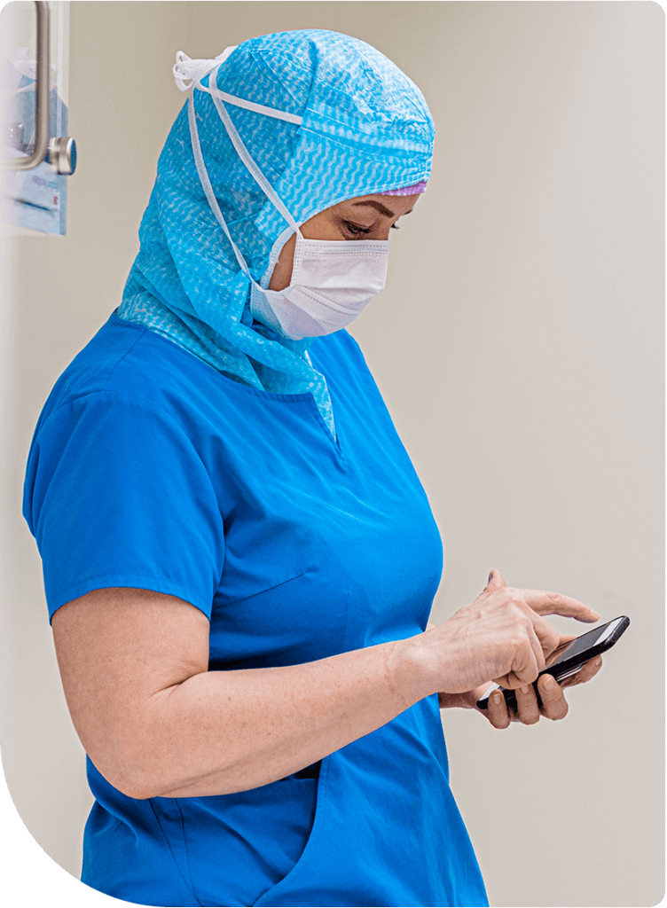 Clinical viewing her mobile phone - on-call scheduling with Spok 